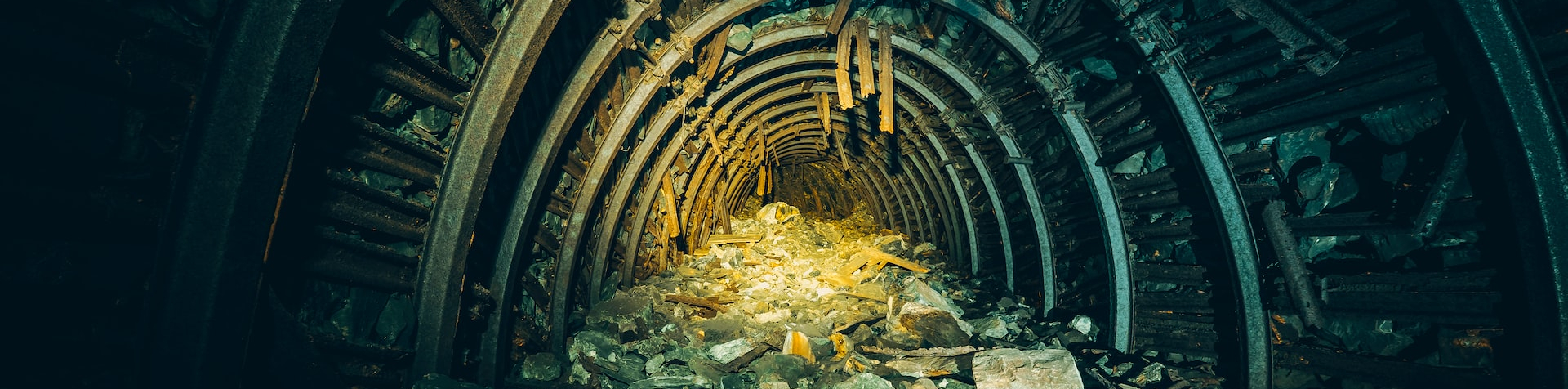 a tunnel filled with rubble next to a pile of rubble