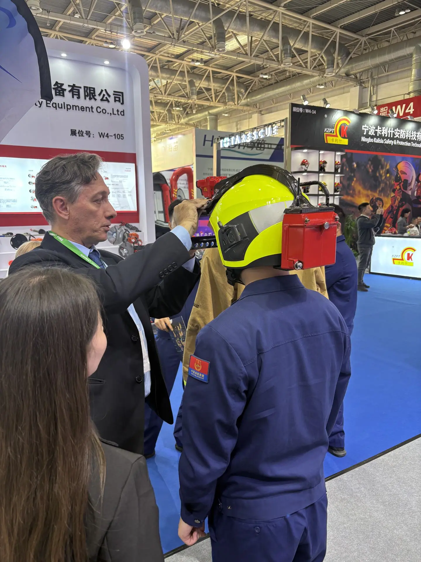 iFalconHM at the China Fire 2025 in Beijing exhibition A person trying on the iFalconHM system at the China Fire exhibition in Beijing